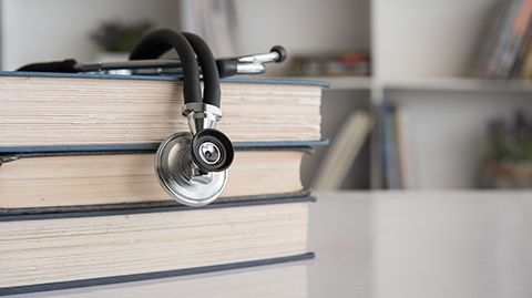 Book with stethoscope on top